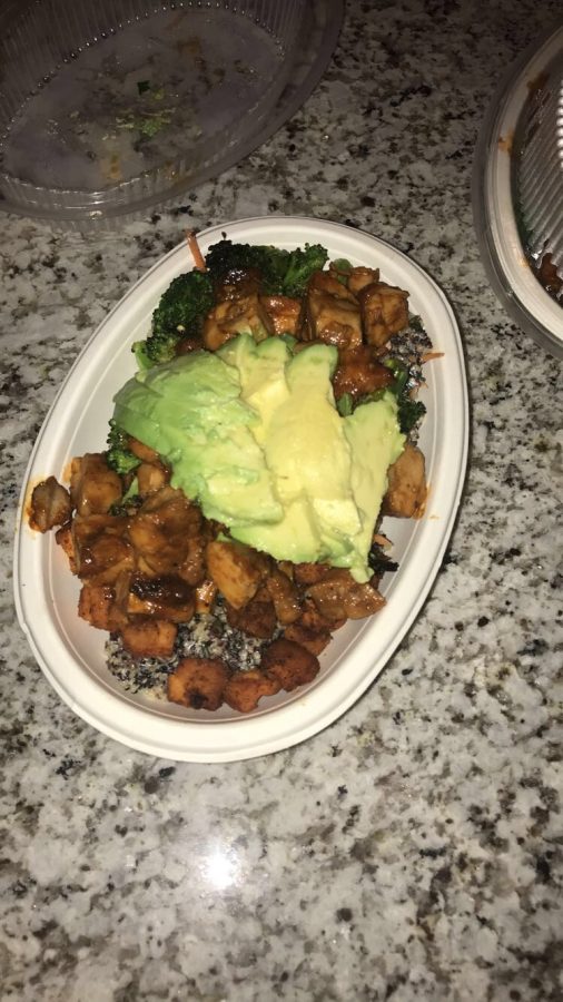 A fresh bowl of quinoa, avocado, barbecue chicken and yams from Bolay.