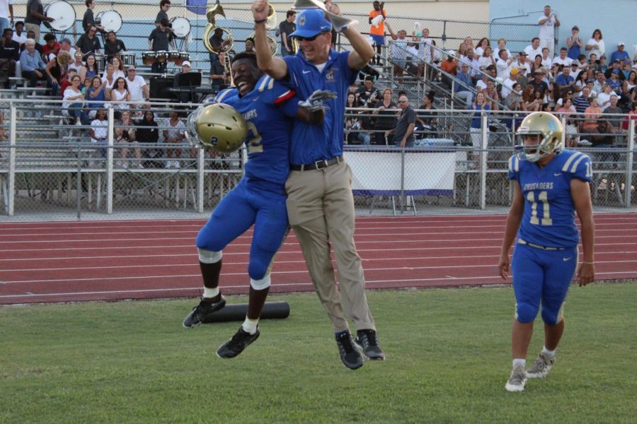 Running Back Chris Dor cant contain his excitement with a Crusader coach.