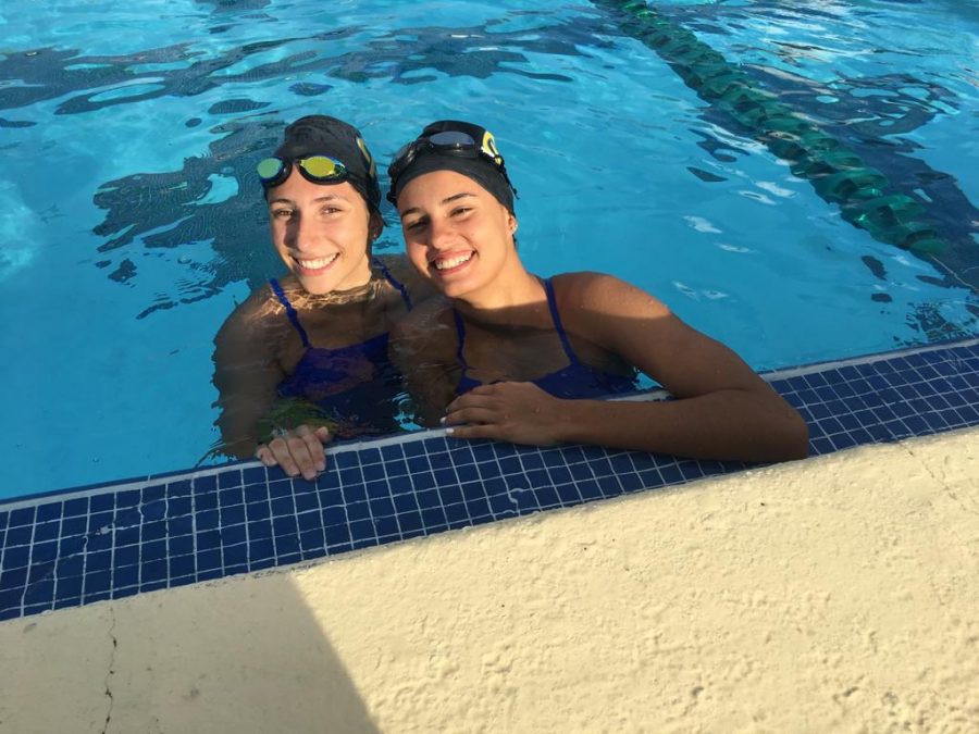 Junior Mara Camacho and Senior Martina Faber relax after a swim meet. 