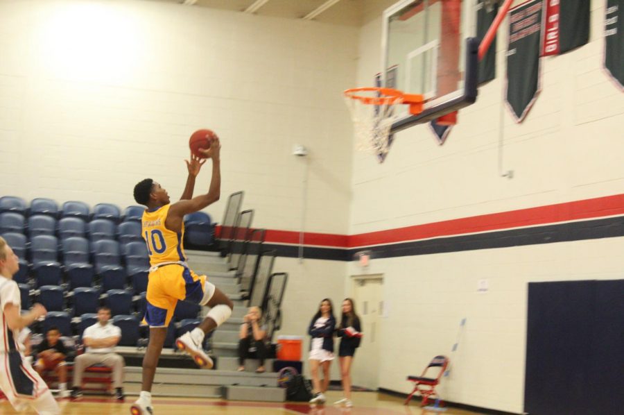 Sophomore Jordan Johnson goes for a lay up against Oxbridge Academy during a regular season game. 